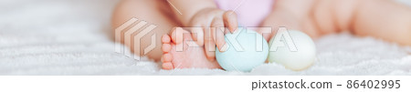 Cute little baby girl, playing with colorful easter eggs Cute little baby girl, playing with colorful easter eggs 86402995