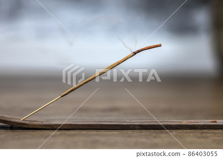 Concept of slow-living and mindfulness. Aromatic saldanwood frankincense smolding stick. Burning candle. Aromatherapy practise. Finding peace and rest. Spiritual ritual at home Concept of slow-living and mindfulness. Aromatic saldanwood frankincense smolding stick. Burning candle. Aromatherapy practise. Finding peace and rest. Spiritual ritual at home 86403055