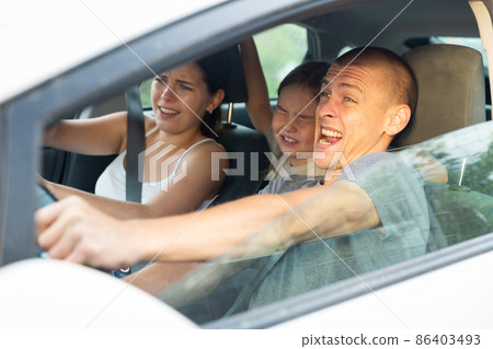 Man driver, his wife and doughter scared screaming in the car Man driver, his wife and doughter scared screaming in the car 86403493