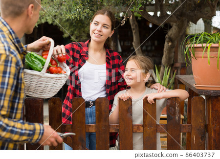 Man offers fresh vegetables to neighbors in country 86403737