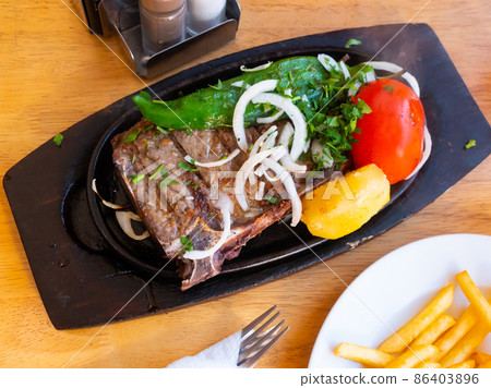 Rustic style grilled veal with potato and vegetables 86403896