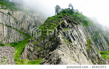 Pillar Rocks of Stolbchatiy cape in Kunashir at Kuril islands, Russia Pillar Rocks of Stolbchatiy cape in Kunashir at Kuril islands, Russia 86403953
