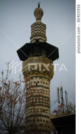 Exterior view to minaret of the mosque at old Damascus, Syria Exterior view to minaret of the mosque at old Damascus, Syria 86403956