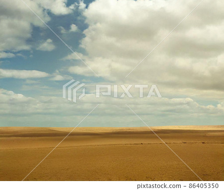 Blue Sky With Clouds Over Desert Landscape With Sand Dunes Blue Sky With Clouds Over Desert Landscape With Sand Dunes 86405350