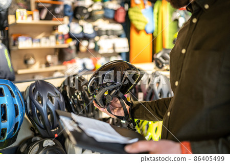 A male bike shop manager makes an inventory of Stock Photo