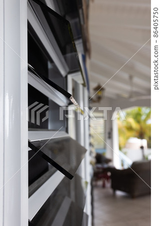 Windows from dark glass blinds. Windows in the tropics. Selective focus. Windows from dark glass blinds. Windows in the tropics. Selective focus. 86405750