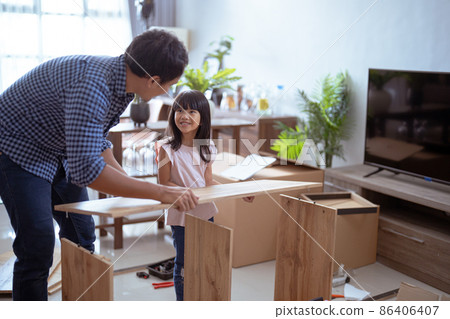 asian father and daughter assembling new furniture at their home asian father and daughter assembling new furniture at their home 86406407