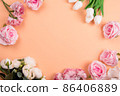 Colorful decorations t with spring flowers on orange background. copy space, top view 86406889