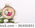 Colorful decorations with Easter egg nest and tulips on white background. copy space, top view 86406891
