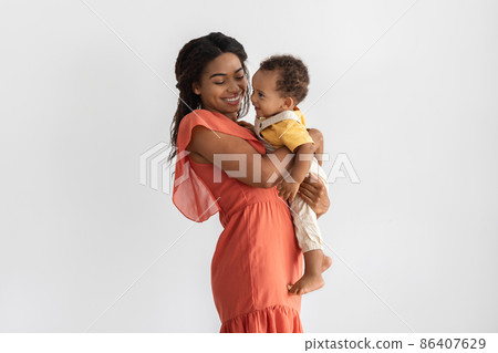 Motherhood Concept. Portrait Of Young Black Mom With Infant Son On Arms 86407629