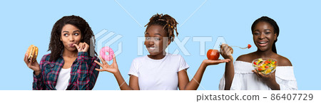 Portrait of Smiling Black Lady Holding Apple And Donut Portrait of Smiling Black Lady Holding Apple And Donut 86407729