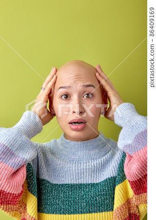 Shocked female touching head by surprise, looking at camera with opened mouth 86409169