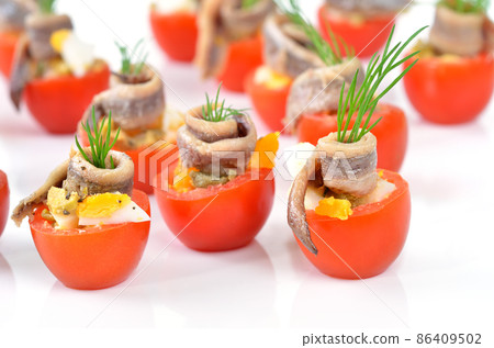 Stuffed cherry tomatoes with anchovy and eggs Stuffed cherry tomatoes with anchovy and eggs 86409502
