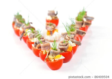 Stuffed cherry tomatoes with anchovy and eggs 86409504
