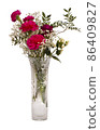Red carnations and red rose bouquet in crystal vase 86409827