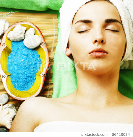 Attractive lady getting spa treatment in salon, close up asian tan hands on face Attractive lady getting spa treatment in salon, close up asian tan hands on face 86410024