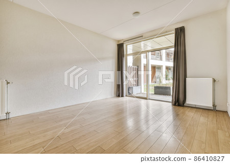 A beautiful room with large windows and dark curtains 86410827