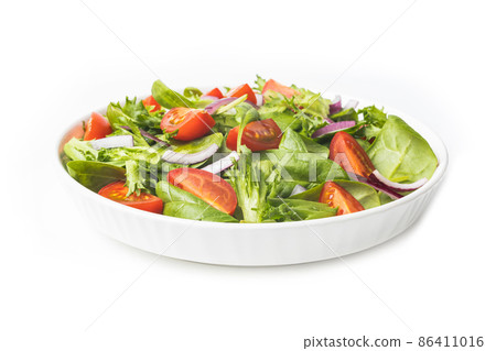 Summre green salad in white bowl plate on grey table 86411016