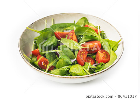 Summre green salad in white bowl plate on grey table 86411017