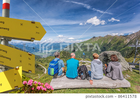 Tourists are watching the lake among Austrian Alps and cable cars in Zell am See-Kaprun region, Austria 86411578