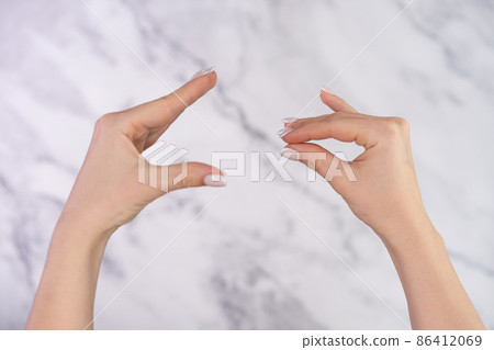 Woman showing bla-bla-bla gesture with hands isolated on marble light background. Empty promises 86412069