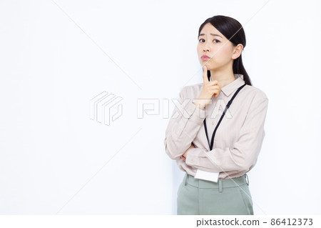 A business woman in her thirties who is worried A business woman in her thirties who is worried 86412373