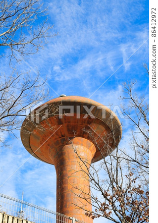 Blue sky and brown rusty UFO-like water tower Blue sky and brown rusty UFO-like water tower 86412972