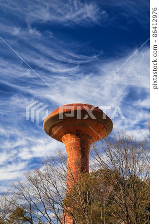 Blue sky and brown rusty UFO-like water tower 86412976