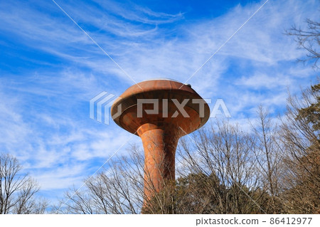 Blue sky and brown rusty UFO-like water tower 86412977