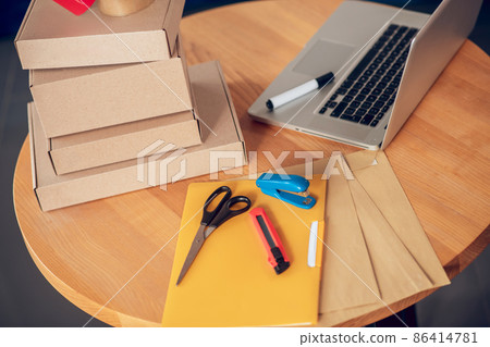 Set of packaging materials and a portable computer on the table Set of packaging materials and a portable computer on the table 86414781