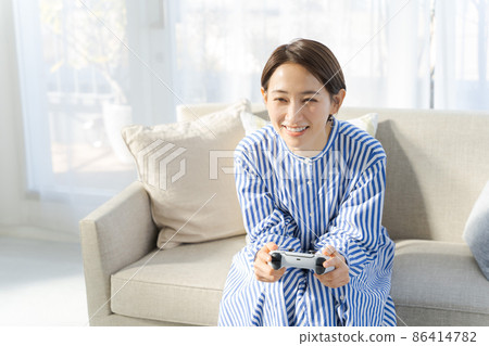 Female in her 40s playing a game Female in her 40s playing a game 86414782