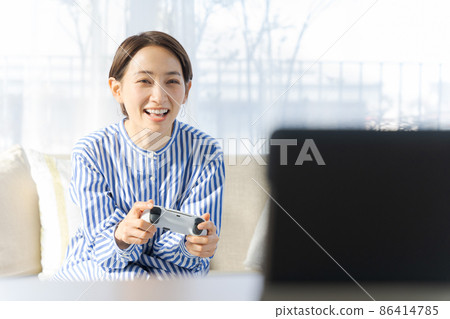 Female in her 40s playing a game Female in her 40s playing a game 86414785