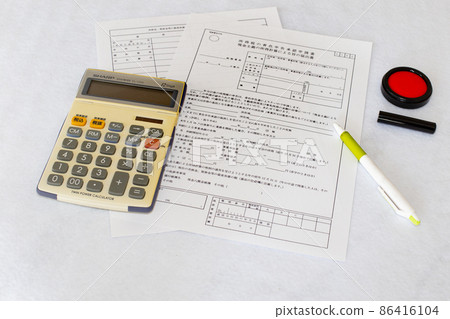 Blue declaration approval application and table photo of calculator and ballpoint pen Blue declaration approval application and table photo of calculator and ballpoint pen 86416104