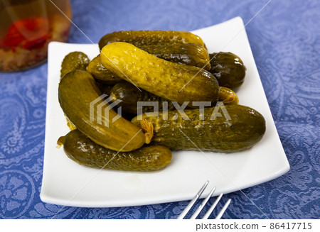 Pickled cucumbers on white plate, homemade preserves 86417715