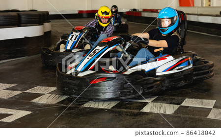 Young people driving sport cars for karting Young people driving sport cars for karting 86418042