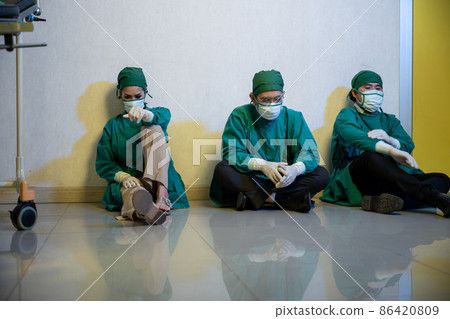 Tired doctor, Group of surgery doctors sadness fatigue after surgery Tired doctor, Group of surgery doctors sadness fatigue after surgery 86420809