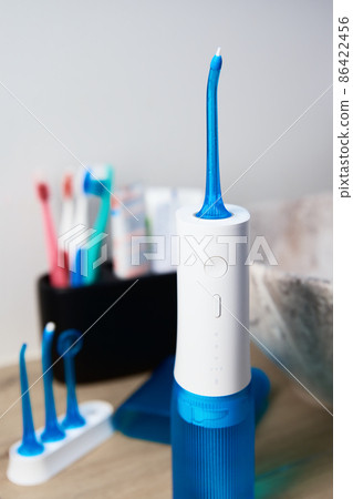 Portable oral irrigator kit in bathroom, waterpik for family use Portable oral irrigator kit in bathroom, waterpik for family use 86422456