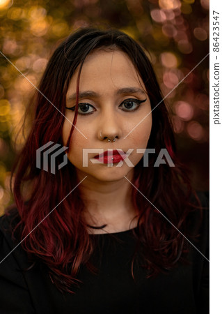 Young caucasian dark haired girl with red streaks in black dress outfit Young caucasian dark haired girl with red streaks in black dress outfit 86423547