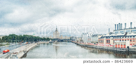 View through glass with raindrops of The Moskva River, Kotelnicheskaya Embankment Building in Moscow, Russia 86423669
