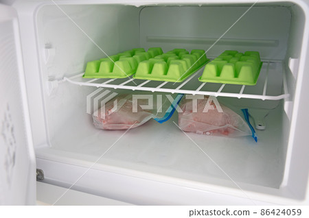 Raw minced meat of  beef in plastic bags in the freezer 86424059
