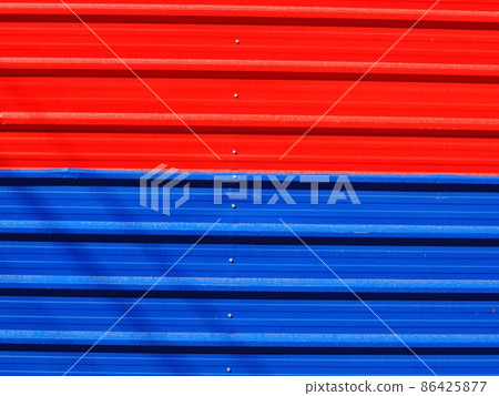 colourful outdoor industrial fence using striped lines long wave galvanised thin metal sheet roof plate crop closeup for backdrop or background use  86425877