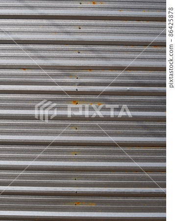 colourful outdoor industrial fence using striped lines long wave galvanised thin metal sheet roof plate crop closeup for backdrop or background use  86425878