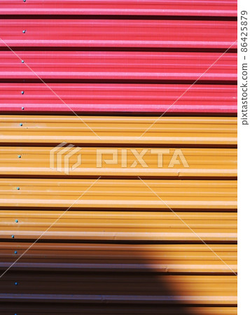 colourful outdoor industrial fence using striped lines long wave galvanised thin metal sheet roof plate crop closeup for backdrop or background use colourful outdoor industrial fence using striped lines long wave galvanised thin metal sheet roof plate crop closeup for backdrop or background use 86425879
