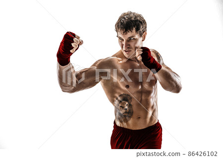 Studio shot of kickboxer who training, practicing uppercut on white background. Red sportswear Studio shot of kickboxer who training, practicing uppercut on white background. Red sportswear 86426102