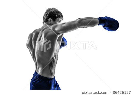 Side view of boxer in blue gloves who practicing swing on white background. Black and white 86426137