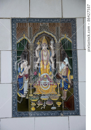 Decorated tiles of deities on the outer wall of Balaji Temple located in Dabhoi, Gujarat, India 86427587