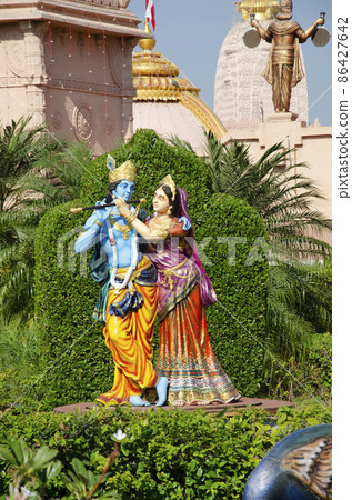 Radha and Krishna playing the flute in garden of Nilkanthdham, Swaminarayan temple, Poicha, Gujarat, India Radha and Krishna playing the flute in garden of Nilkanthdham, Swaminarayan temple, Poicha, Gujarat, India 86427642