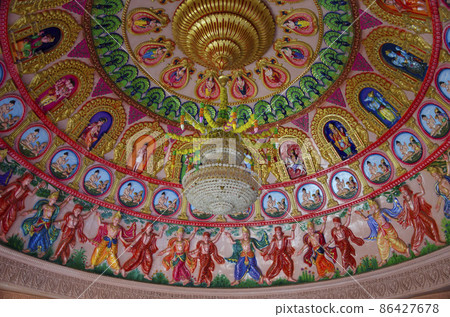 Interior ceiling of Swaminarayan temple with gods, deities and dancing figures carved on the same. Nilkanthdham, Poicha, Gujarat, India 86427678
