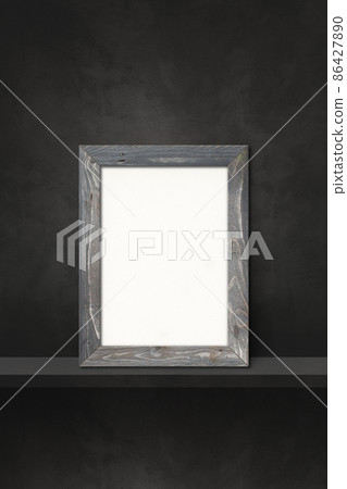 Wooden picture frame leaning on a black shelf. 3d illustration. Vertical background 86427890