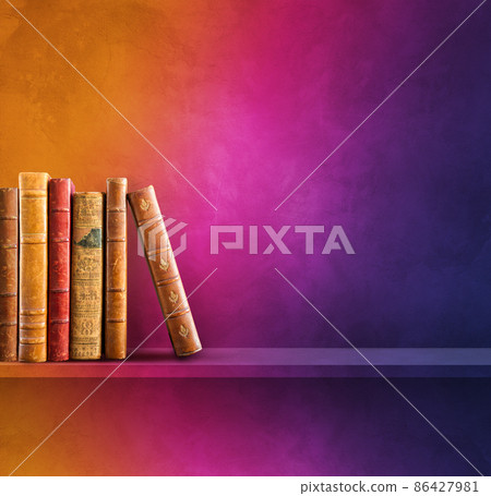 Row of old books on rainbow shelf. Square background 86427981